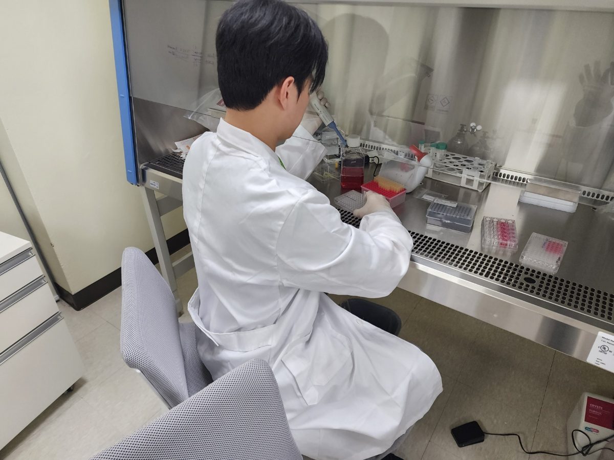 AiderBio researcher working in a biosafety cabinet